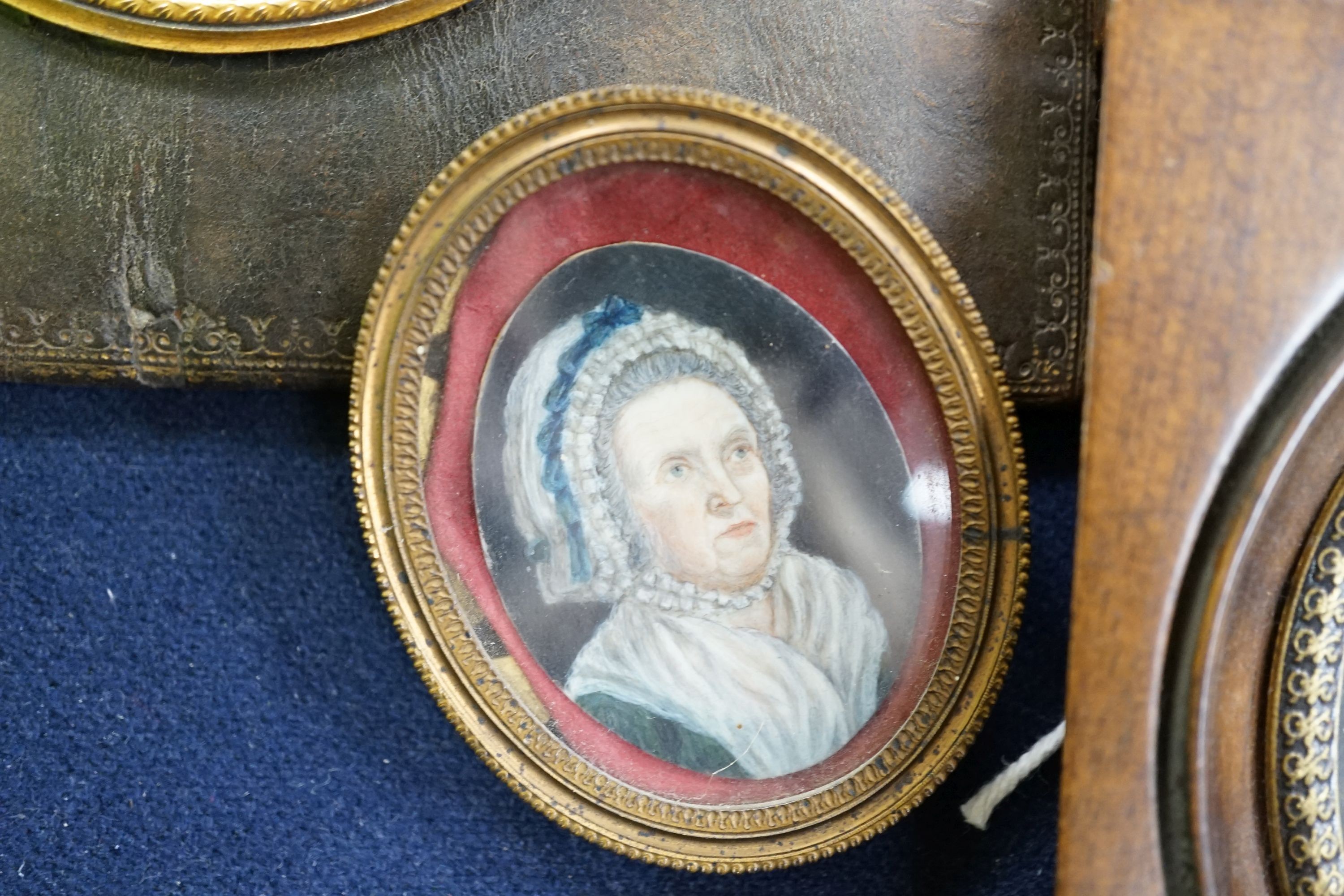 A group of four framed portrait miniatures, tallest 9cm